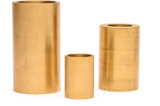 Three brass cylinders are lined up in a row.